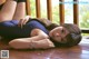 A woman laying on a wooden deck with her legs crossed.