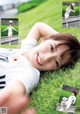 A young woman laying on the grass with a soccer ball.