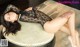 A woman in a black lingerie laying on a drum.